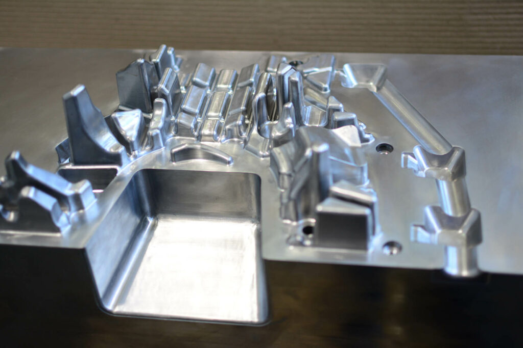 Angled view of die mold used for forming intricate automotive parts