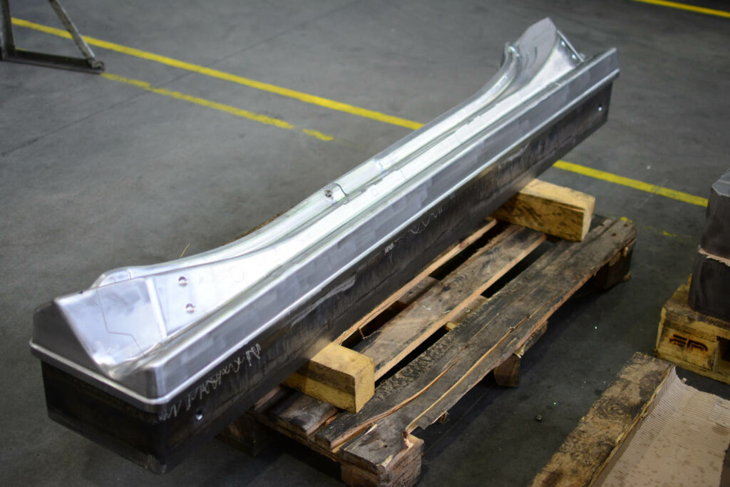 Large die mold for shaping automotive door panel sections