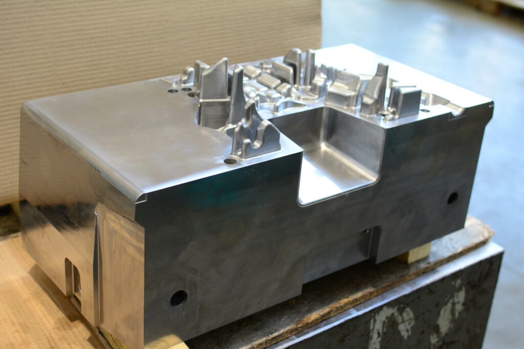 Polished automotive die mold showcasing complex cavity structure