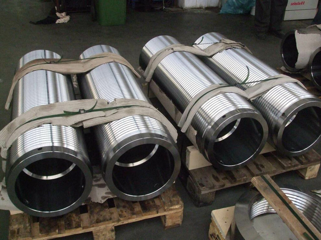Deeply threaded hollow cylindrical components precisely machined and palletized, used in nuclear energy plant