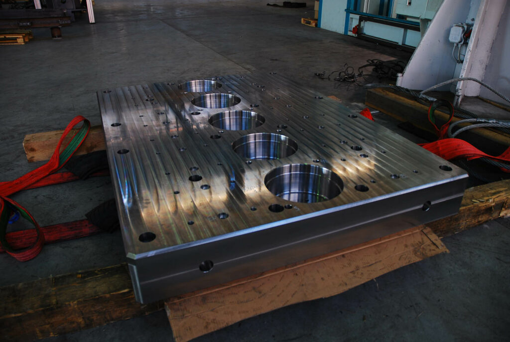 Large precision-machined steel plate with multiple bore holes