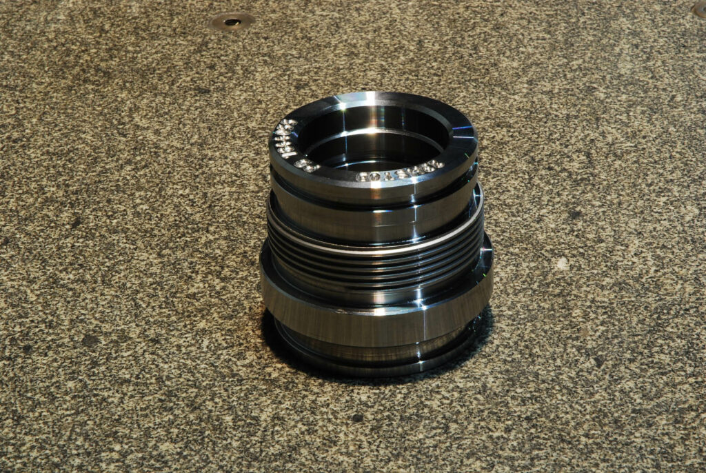 Threaded sealing fitting for oil and gas pipelines, shown on granite table