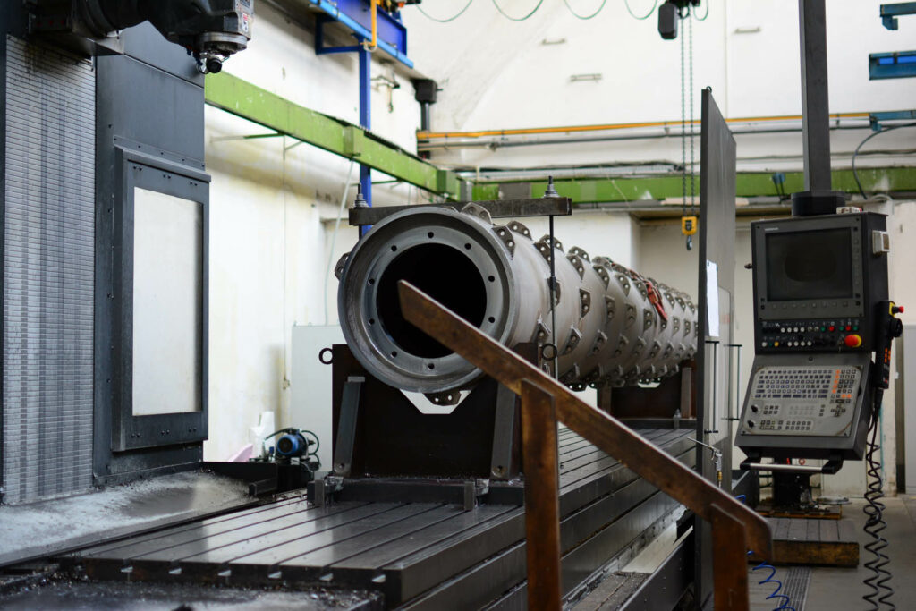 CNC setup for precision boring of a rotor used in pulp and paper processing systems